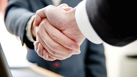 Cushman & Wakefield and DTZ ink merger pact